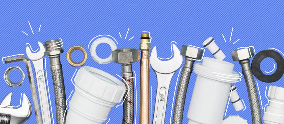 group of wrenches and PVC pipes on blue background