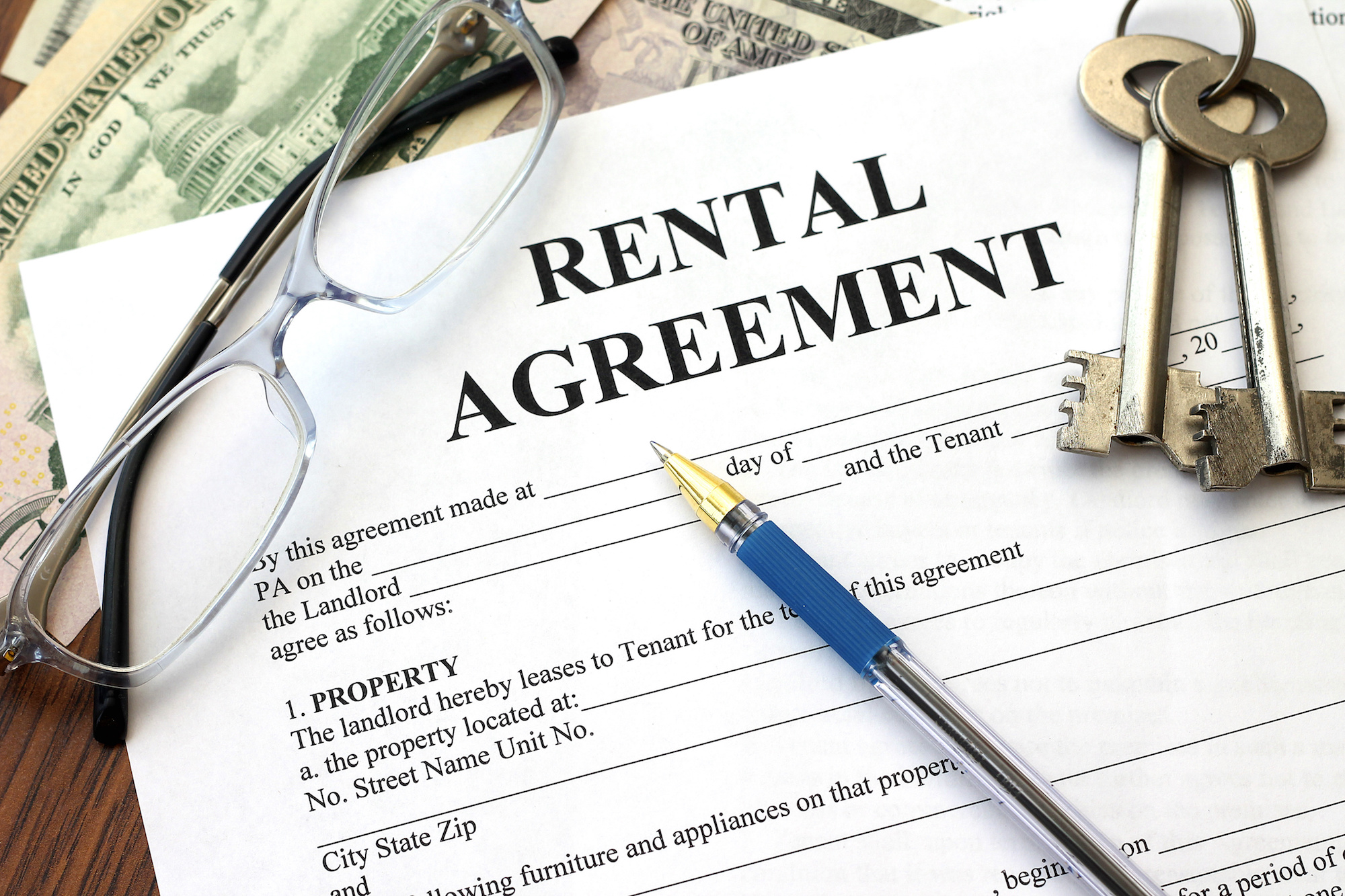 Rental agreement contract on a desk with a pen. 