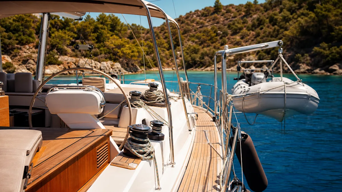A yacht deck with the bimini rigged, guardrails and a tender on davits