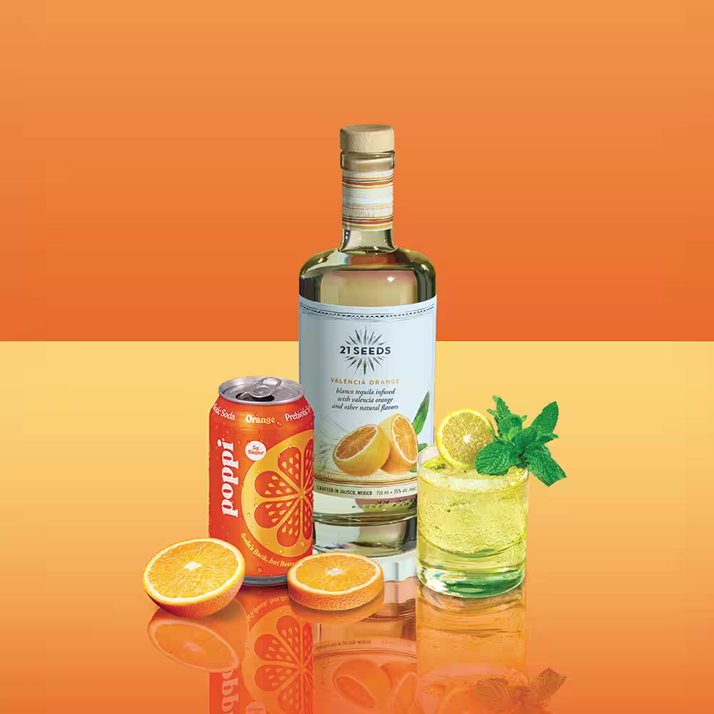 21 Seeds Poppi Orange Bottle Can orange slices and tumbler of cocktail