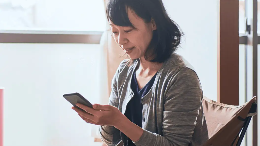 A woman works on her phone