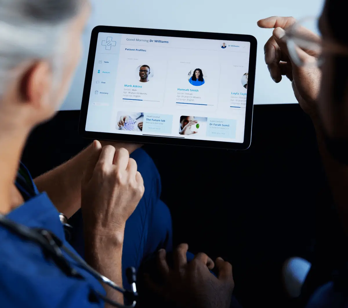 Healthcare professionals review patient profiles on a tablet