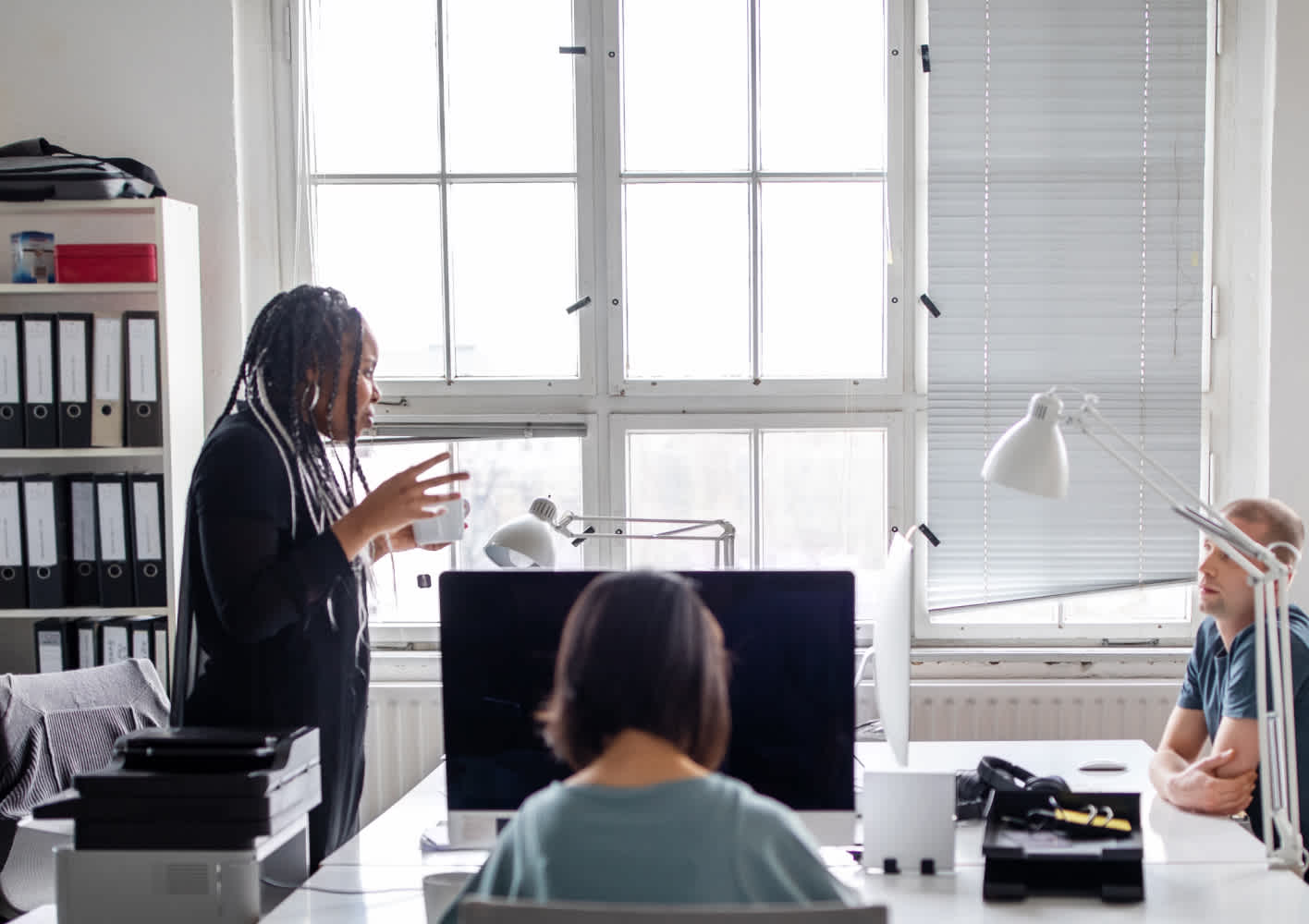 Group of people working in an open plan office.