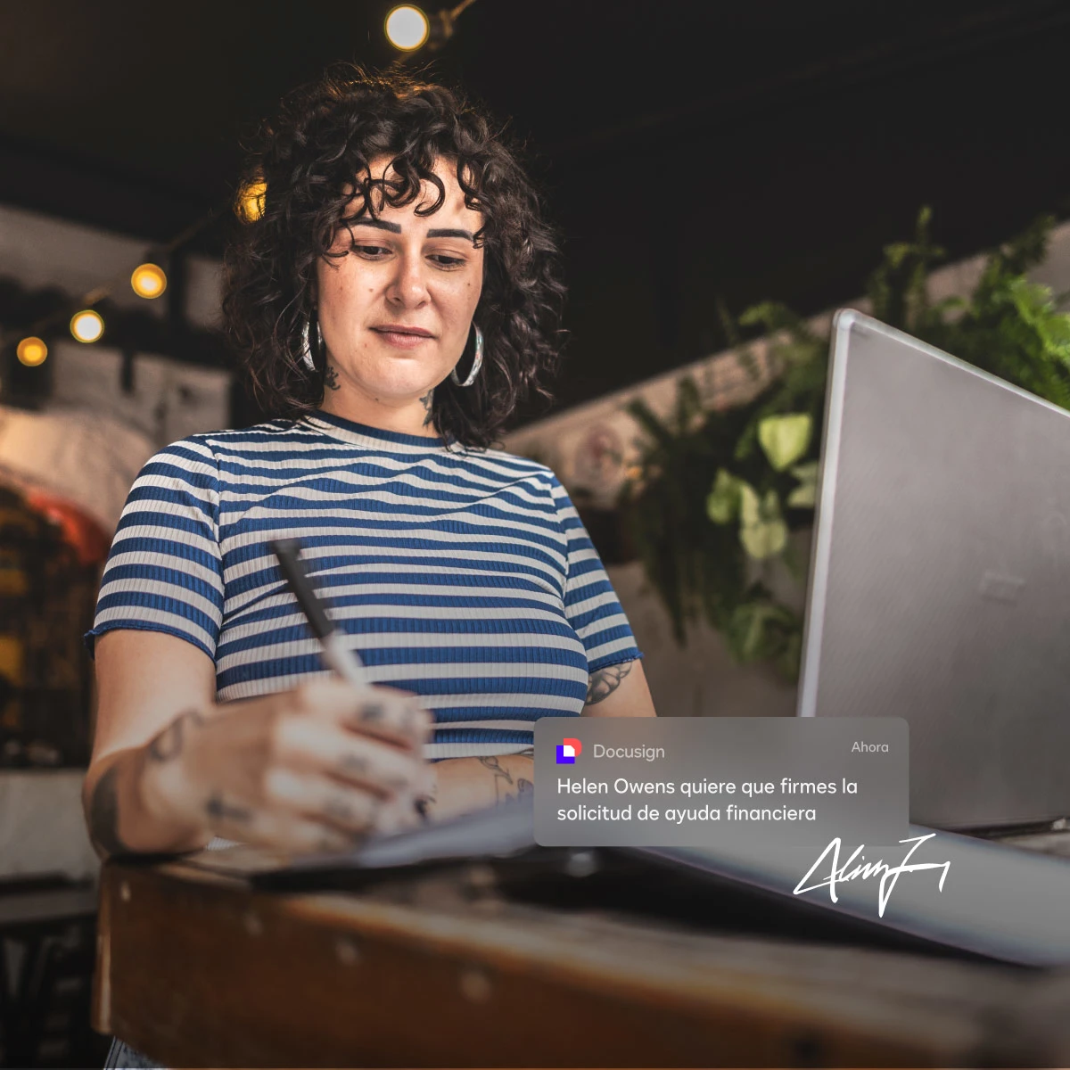 Woman working with laptop and writing notes