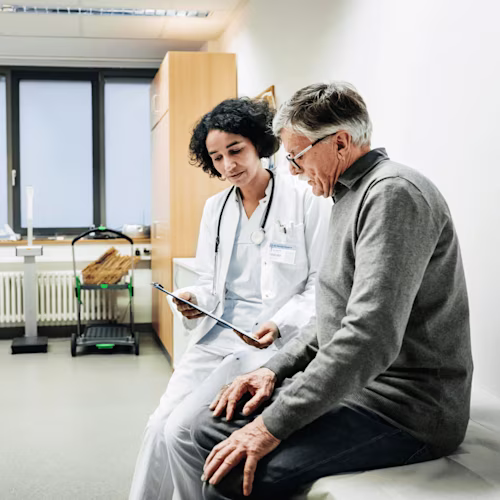 A doctor reviews a document with a patient