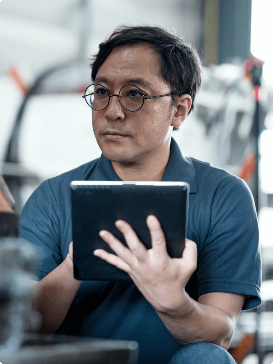 Man in glasses works on a tablet