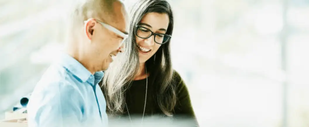 Two people with glasses talking