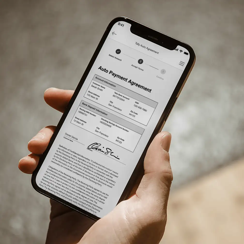 Hand holding a phone showing a contract with Tally via Docusign