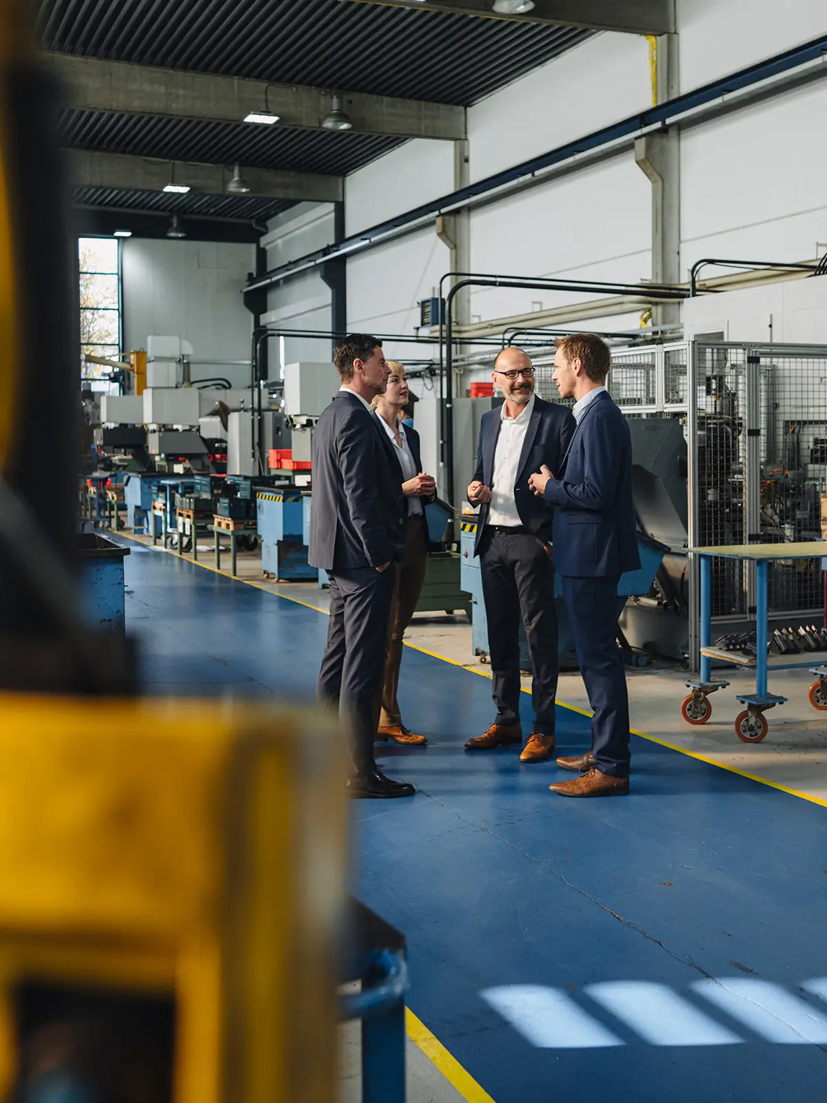 Group of men standing in a factory