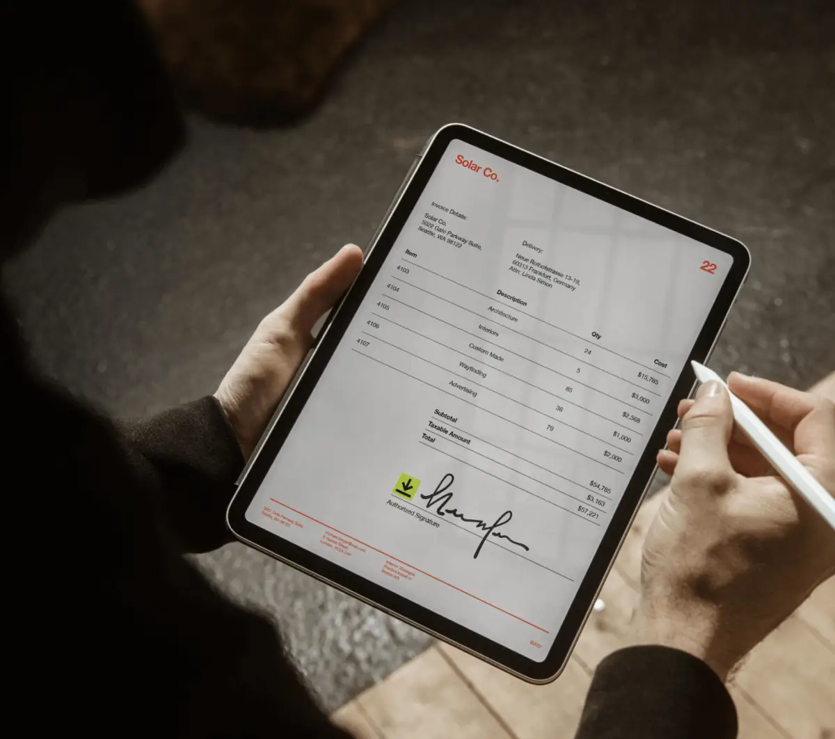 A solar manufacturing company uses DocuSign eSignature on a tablet to sign an invoice.