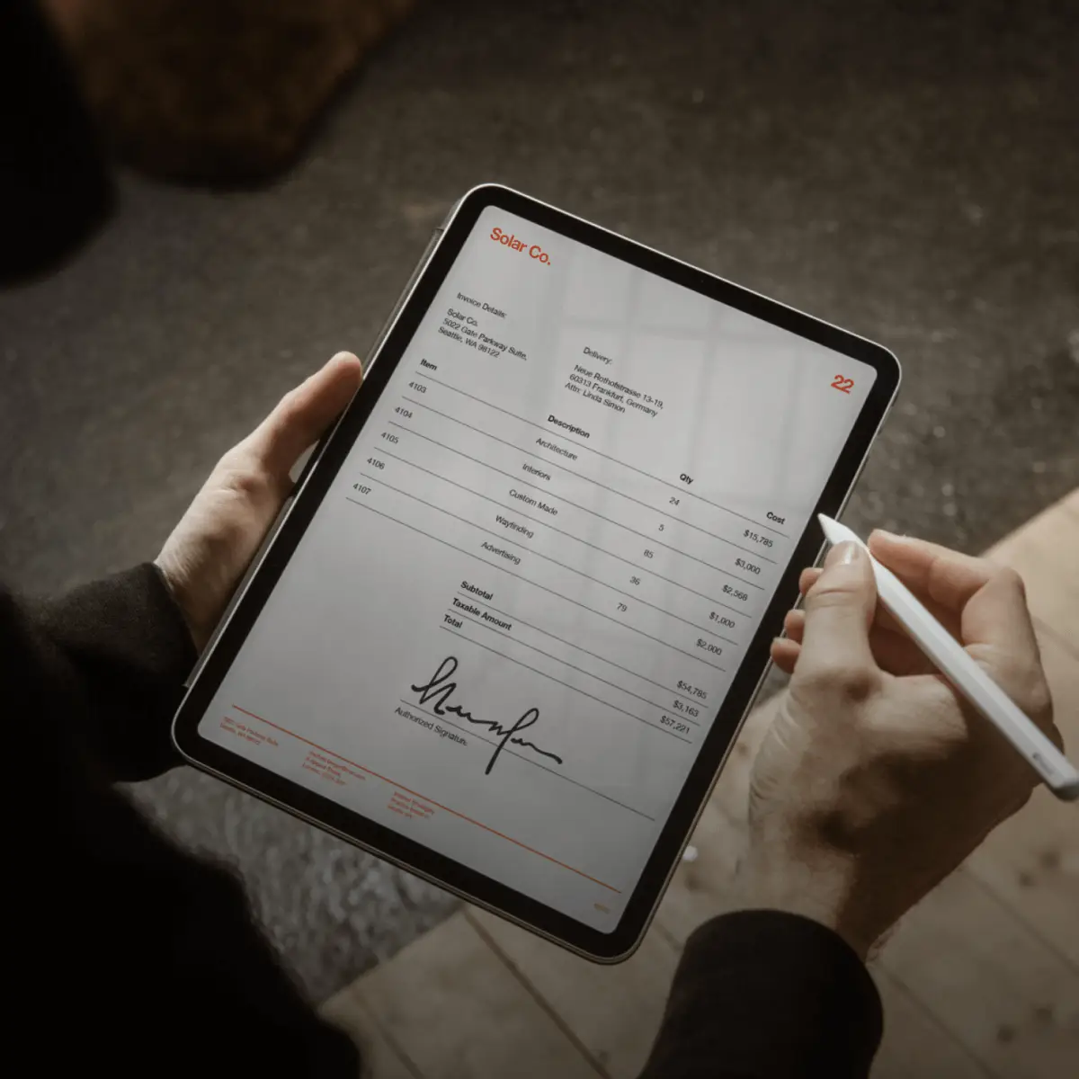 A solar manufacturing company uses DocuSign eSignature on a tablet to sign an invoice.