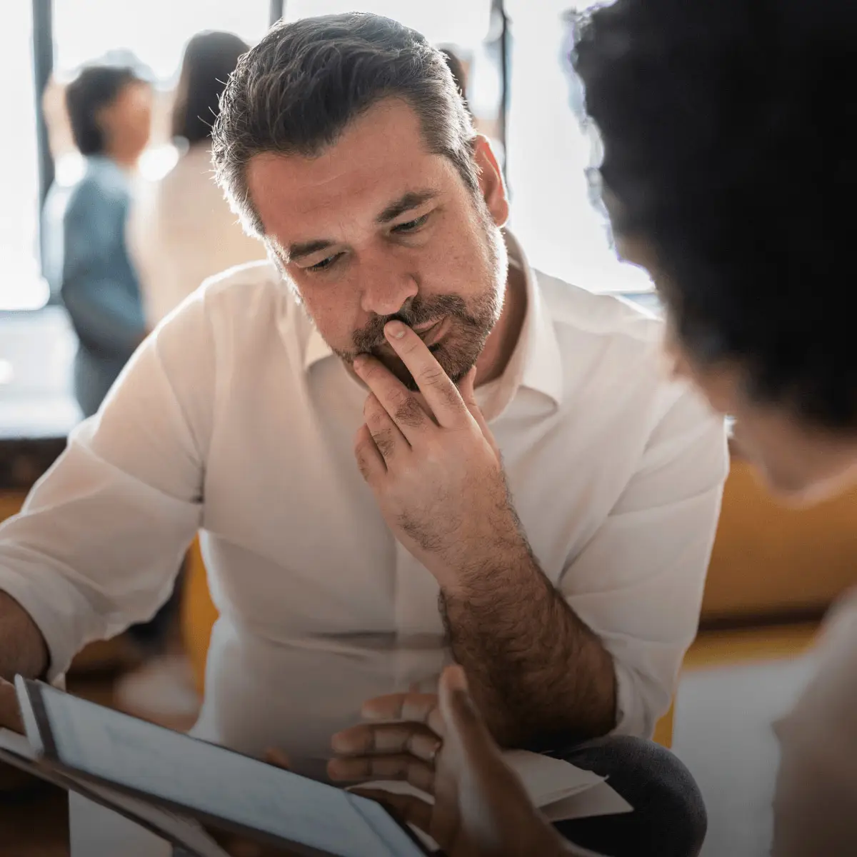 A notification from DocuSign asks a user to sign a Medicaid application form, and an applicant signs the form on a tablet.