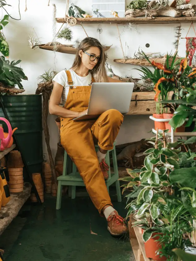 Woman on a laptop in a plant store