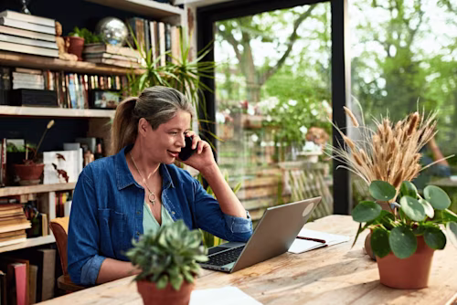 A woman working in a sunny home office uses Data Verification