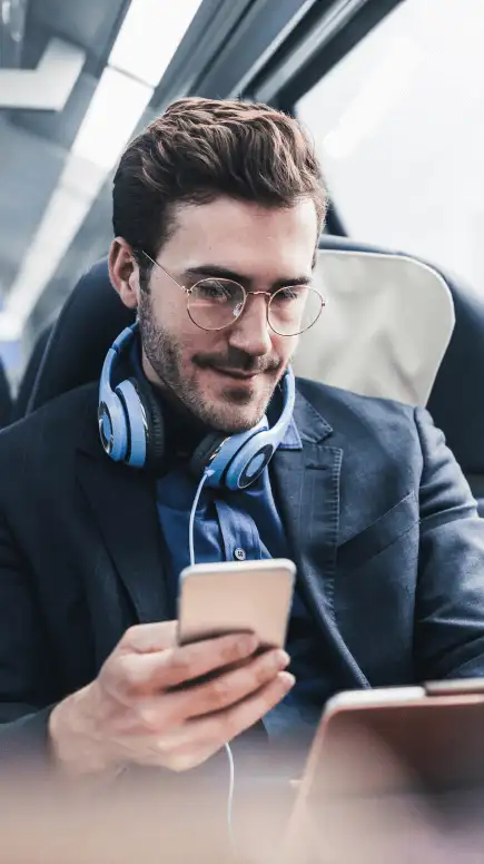 Man on public transportation looking at his phone reviewing the DocuSign economist report
