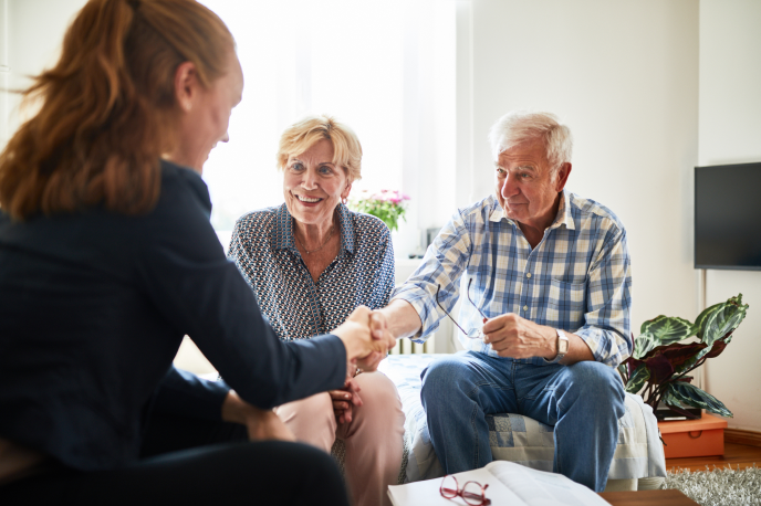 Businesswoman coming to an agreement with an elderly couple
