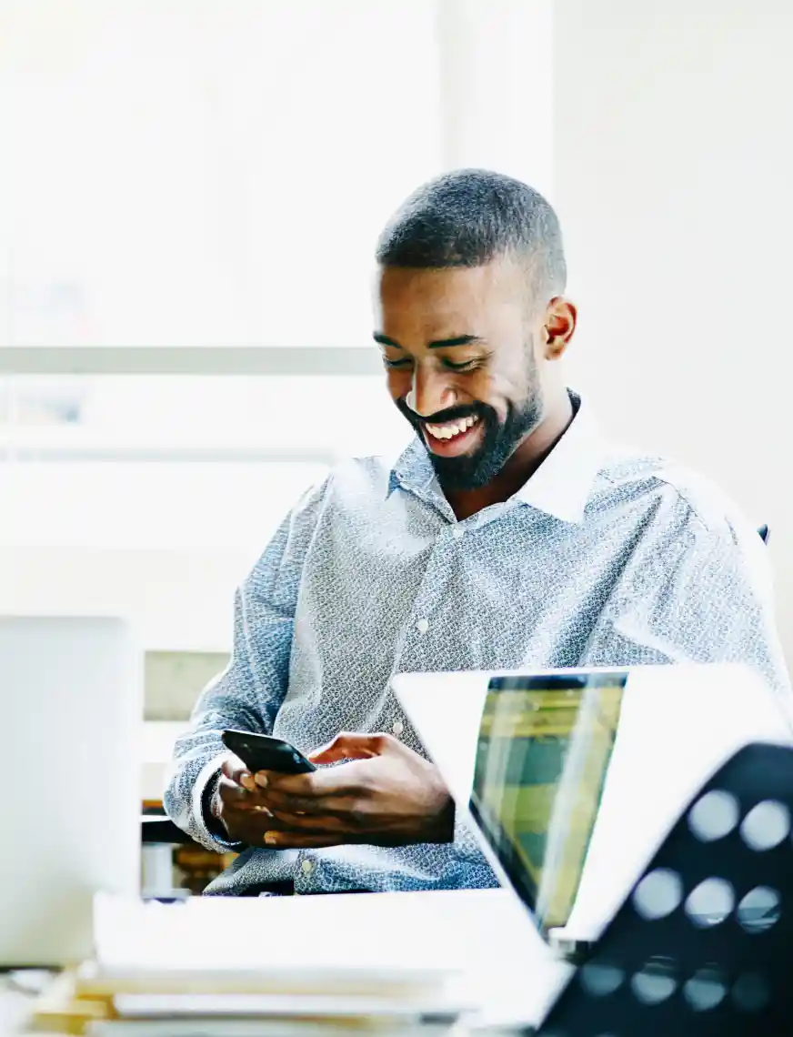 Glimlachende zakenman, werkend op zijn smartphone