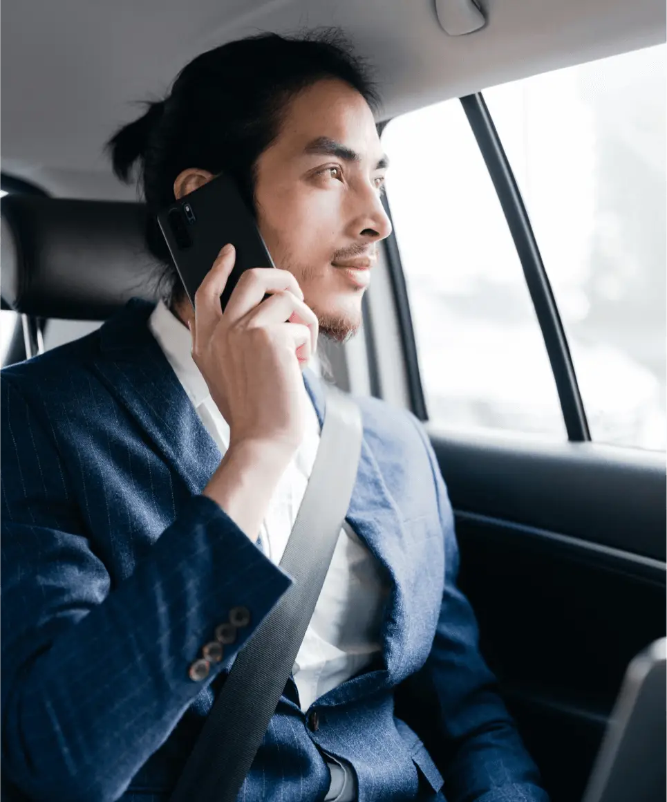 Man talking on mobile in car