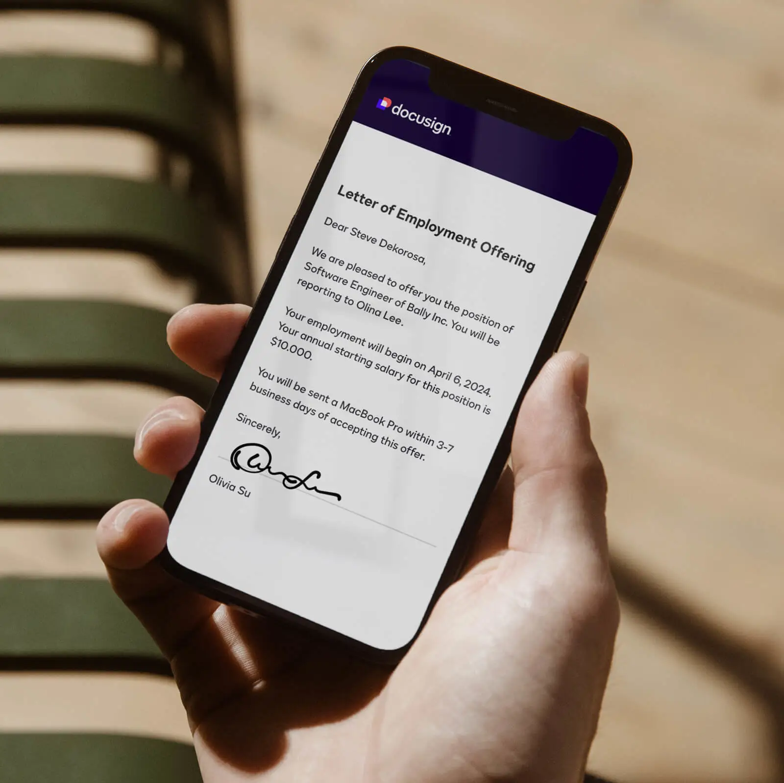 A phone screen showing a letter of employment offering signed with DocuSign.