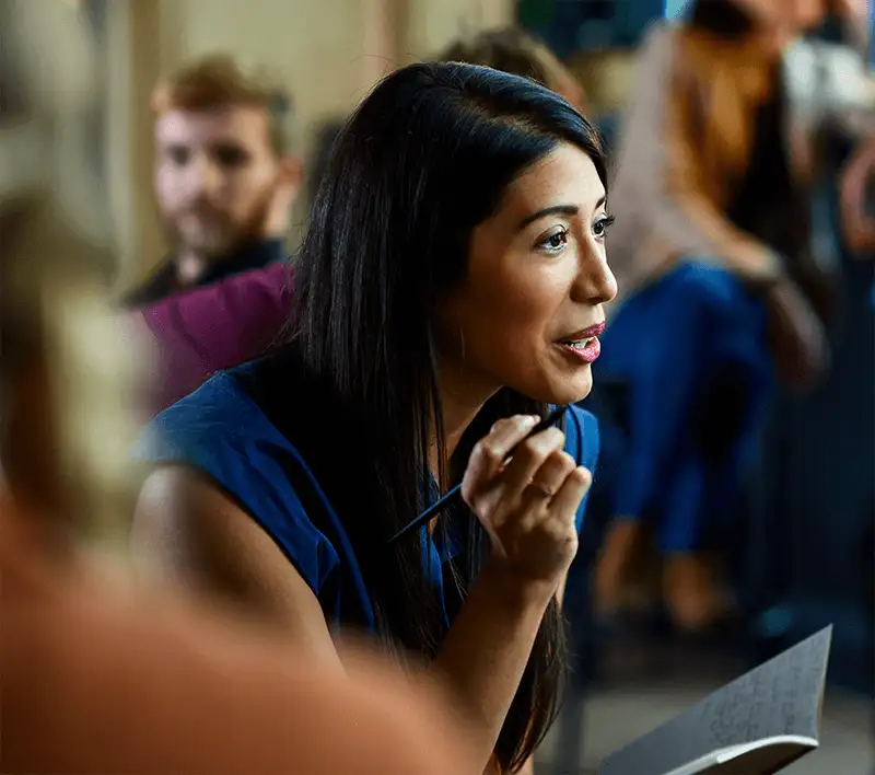 Businesswoman taking notes using a pen during a meeting 