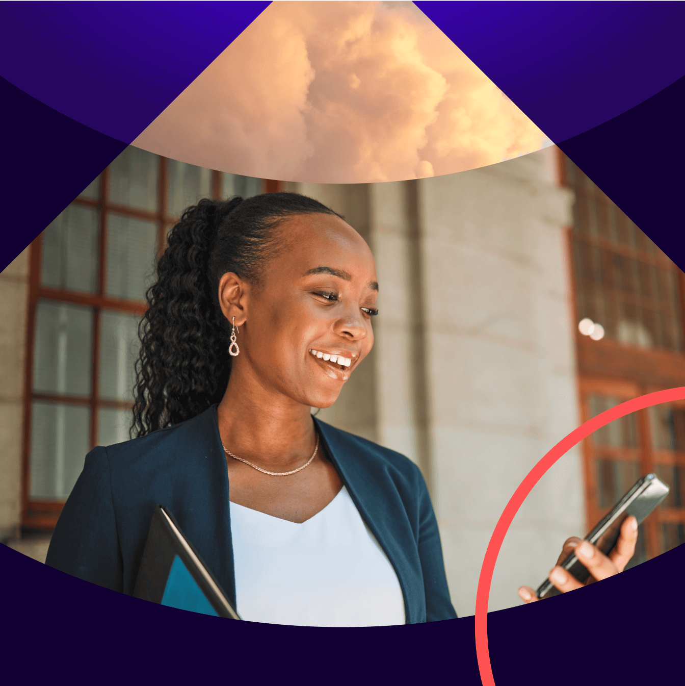 A smiling woman looking at her phone. 