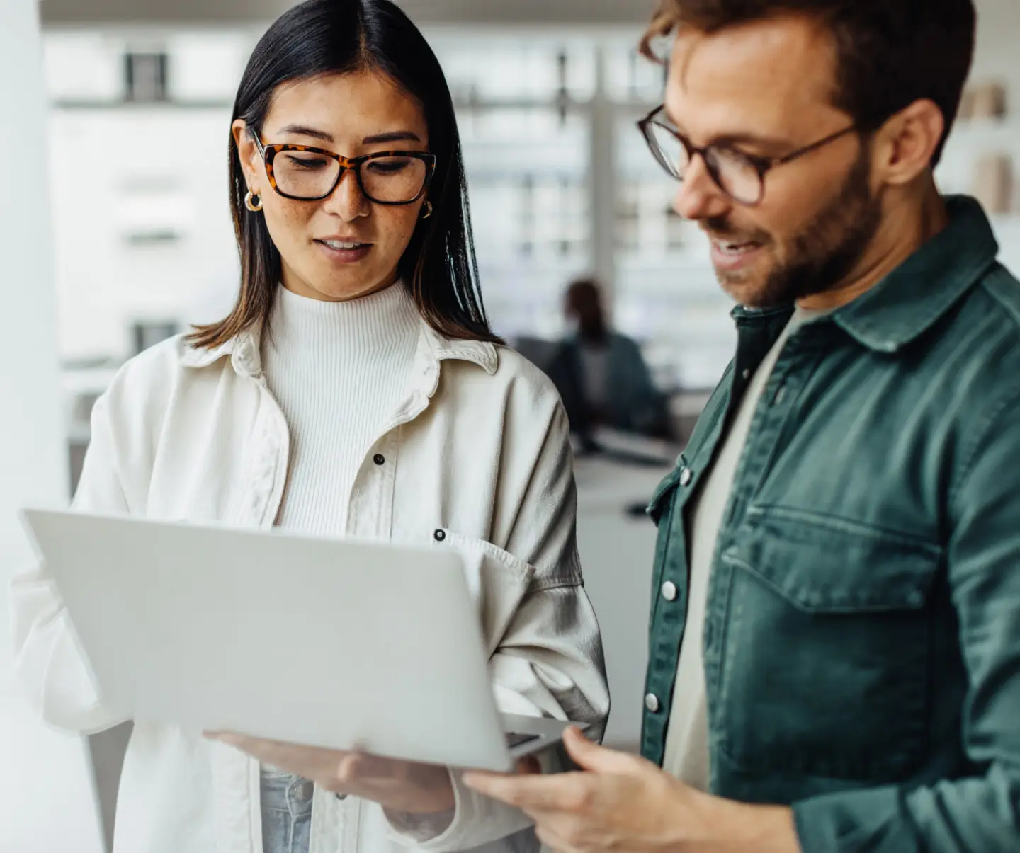 Business man and woman reviewing content of laptop screen