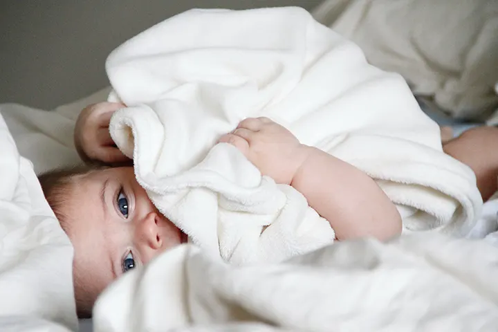 Μωρό σε κρεβάτι με κουβέρτα