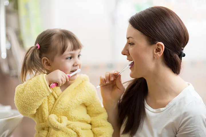 mum toddler brushing teeth