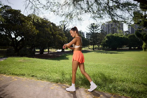 Kayla Itsines walking in park