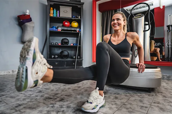 Woman using  vibration plate