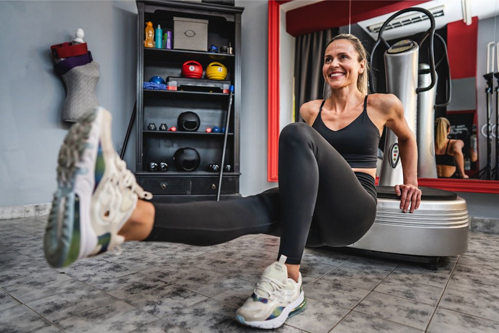 Woman using  vibration plate