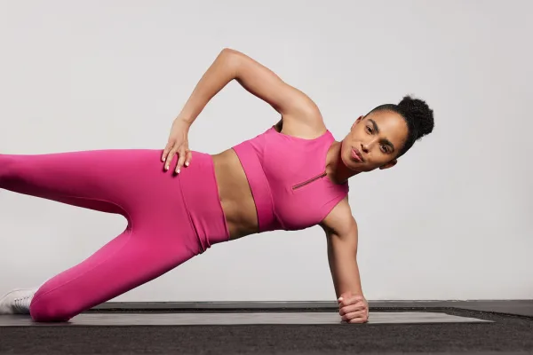 Britany Williams side plank in pink