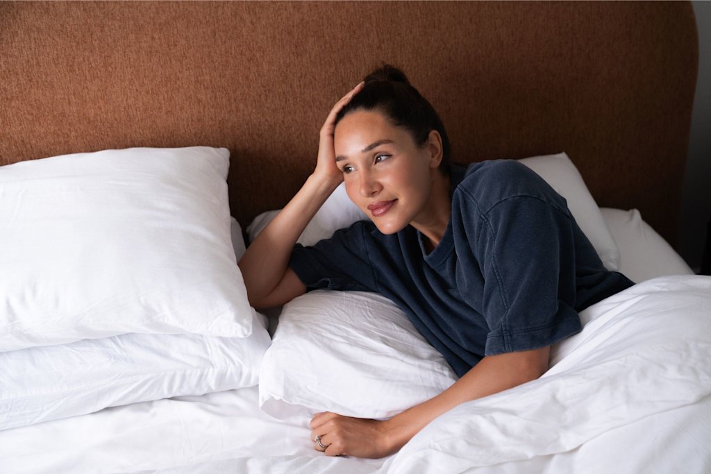 Kayla Itsines lying in bed