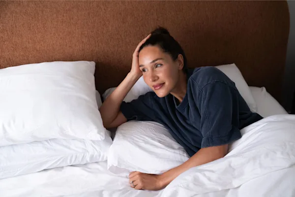 Kayla Itsines lying in bed