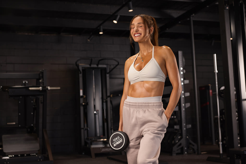 Kayla Itsines holding dumbbell