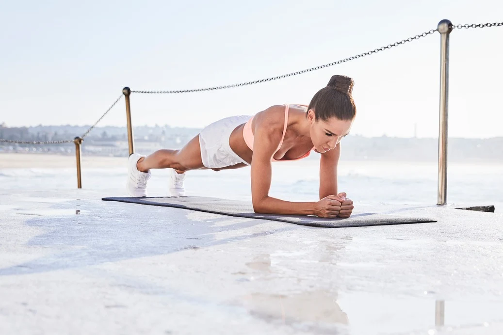 Kayla planking by the beach