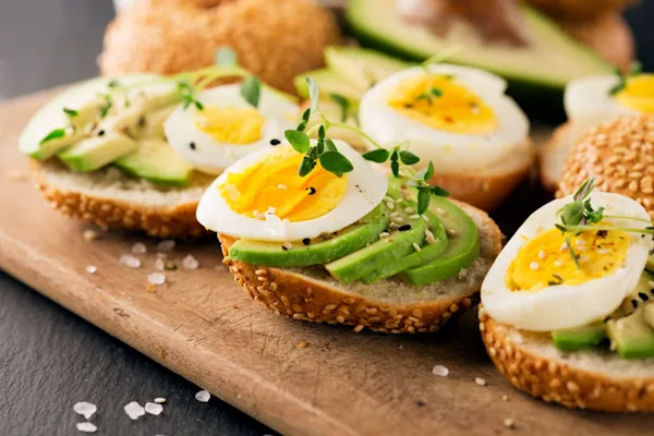 Sliced eggs and avocado on toast