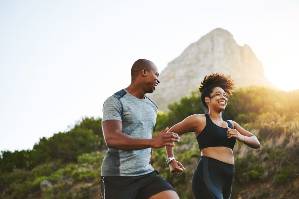 Couple running on a mountain 