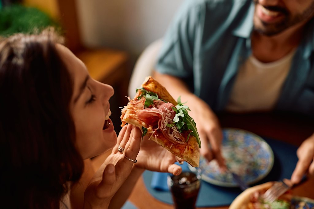 Woman eating pizza