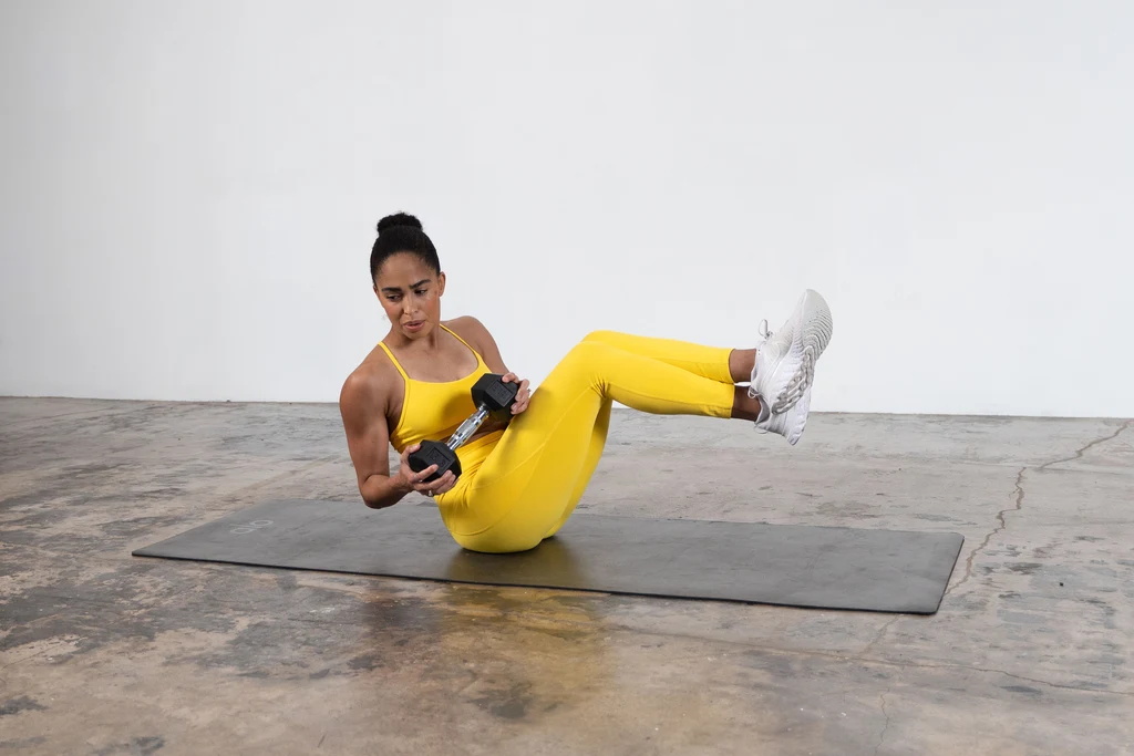 Britany Williams yellow activewear dumbbells yoga mat