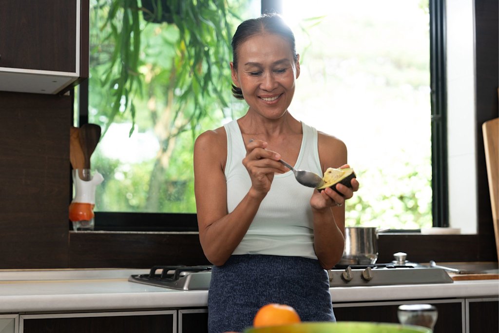 Woman eating avocado