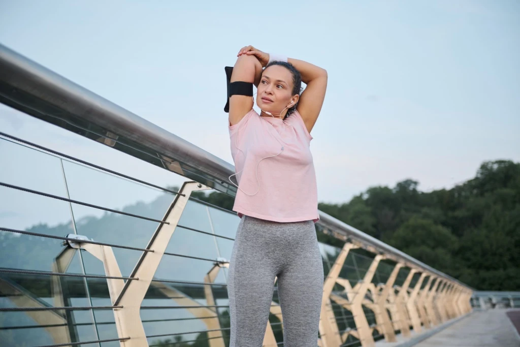 Woman stretching on bridge