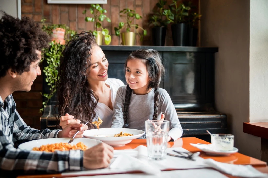 Family of three eating meal