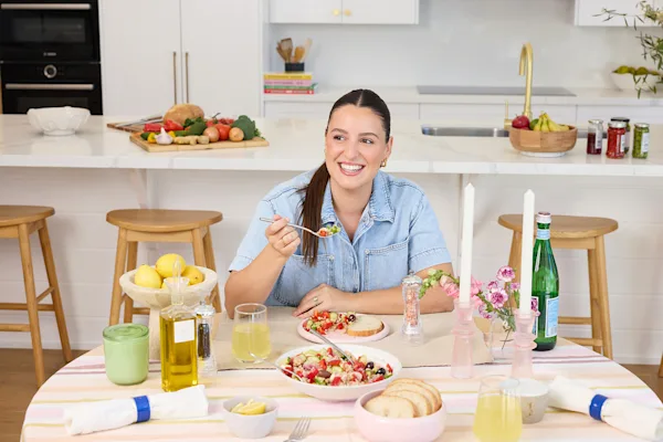 Leah Itsines sitting at table