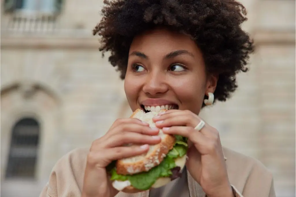 Woman eating sandwich