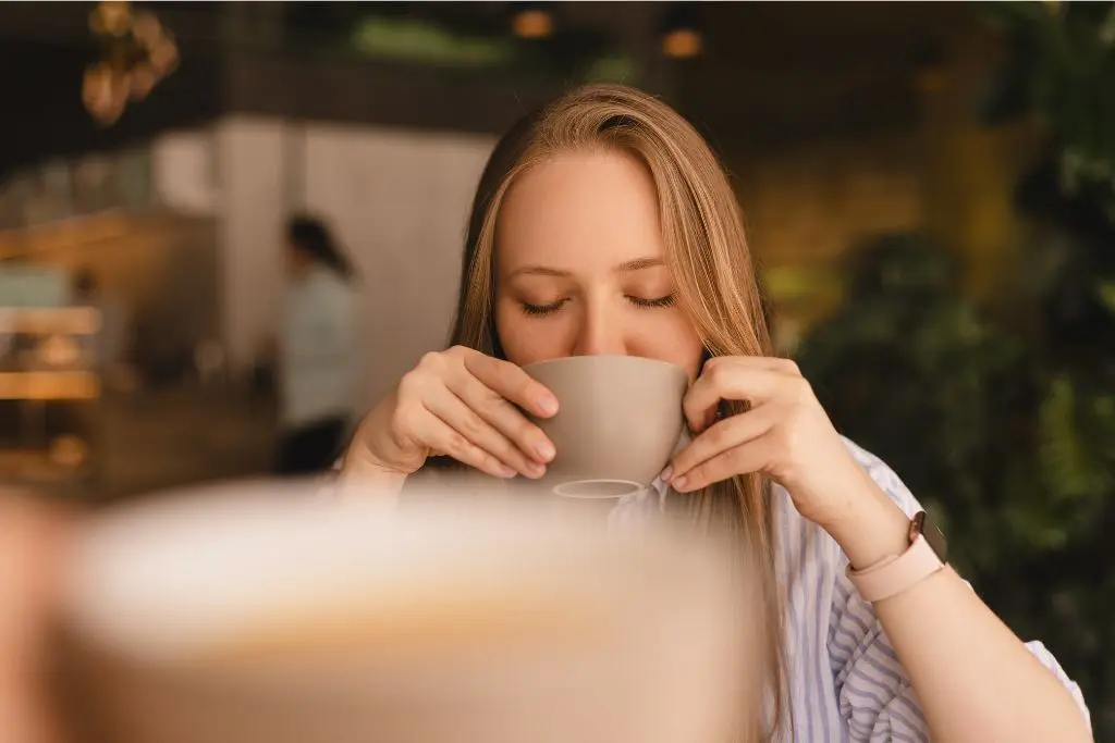 Woman drinking cup of coffee