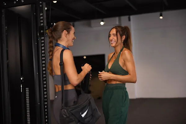 Erin and Kayla laughing in gym