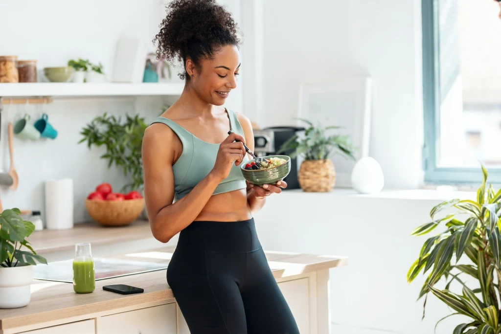 Woman eating breakfast bowl