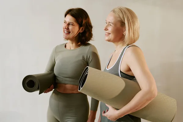 Women holding yoga mats