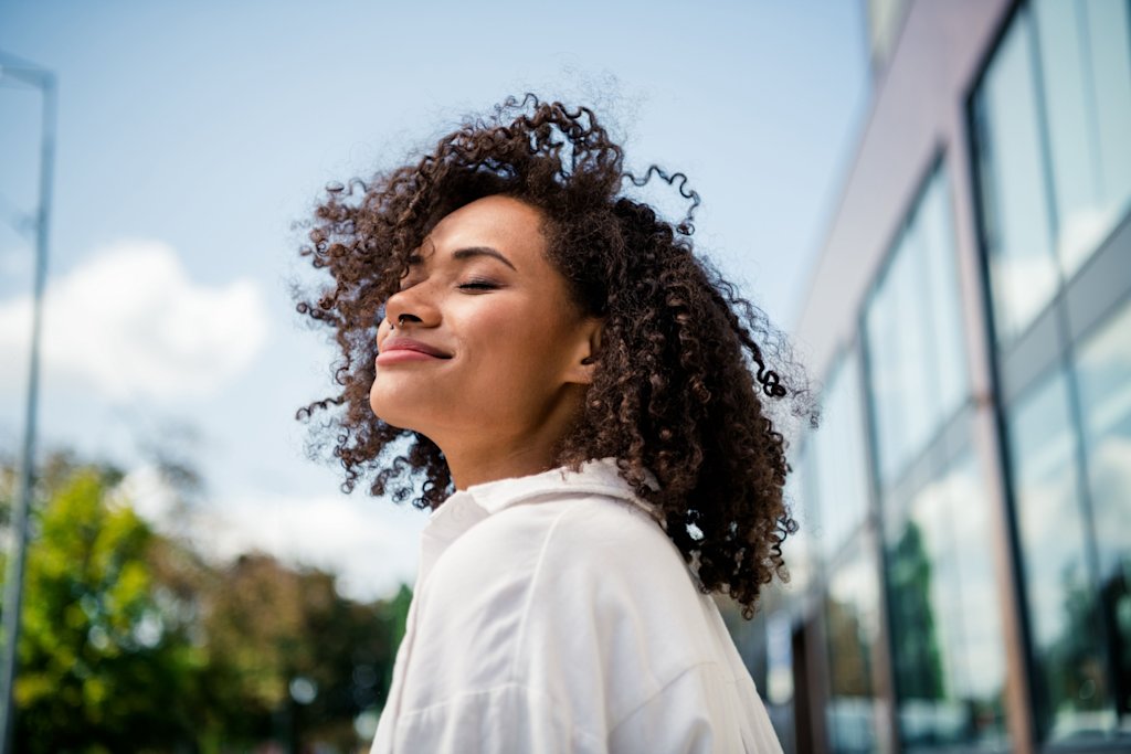 Woman eyes closed smiling